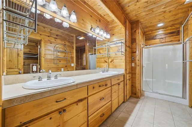 a bathroom with a granite countertop shower and a sink