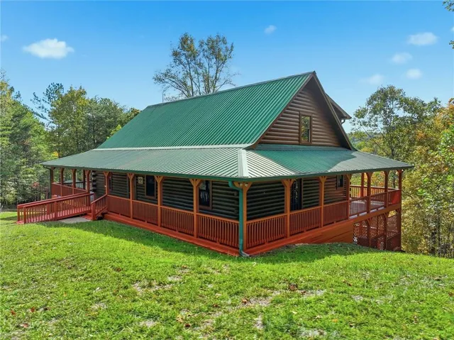 a view of a house with a yard and sitting area