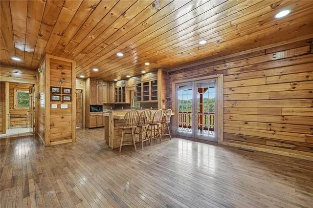 a kitchen with a stove a sink and wooden floor