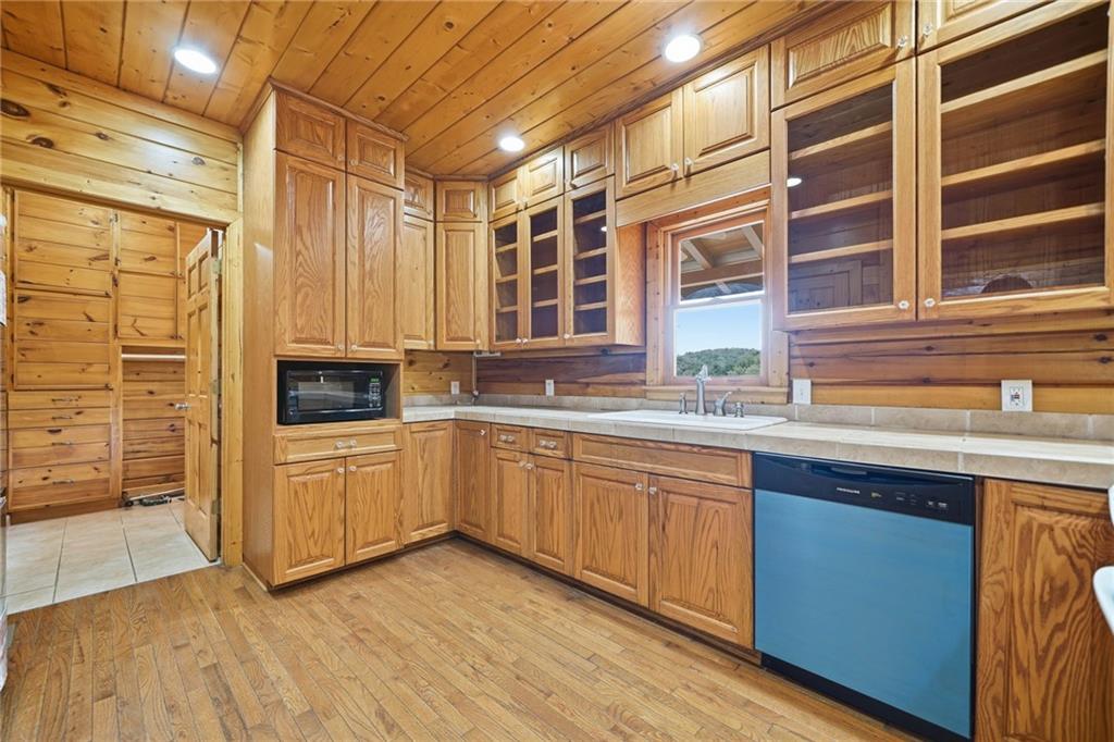 1384 Crystal Lane Northeast Ranger, GA 30734 - Photo 24 of 53 a kitchen with stainless steel appliances granite countertop a sink and cabinets with wooden floor