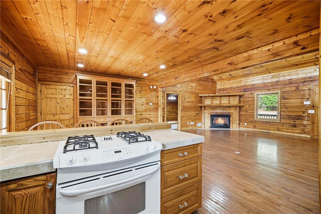 1384 Crystal Lane Northeast Ranger, GA 30734 - Photo 27 of 53 a kitchen with a stove a sink and wooden floor