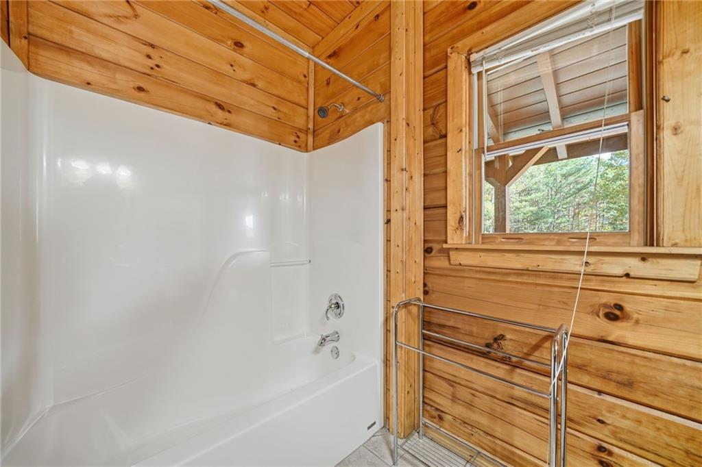 1384 Crystal Lane Northeast Ranger, GA 30734 - Photo 29 of 53 a bathroom with a bathtub and window