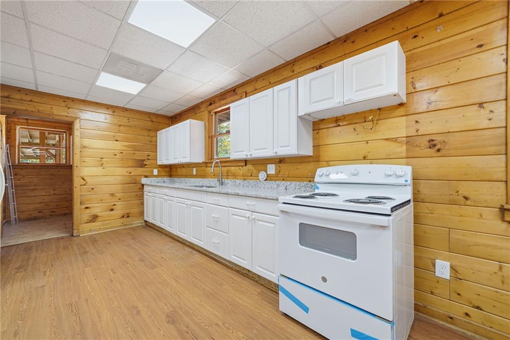 1384 Crystal Lane Northeast Ranger, GA 30734 - Photo 46 of 53 a kitchen with granite countertop white cabinets and white appliances