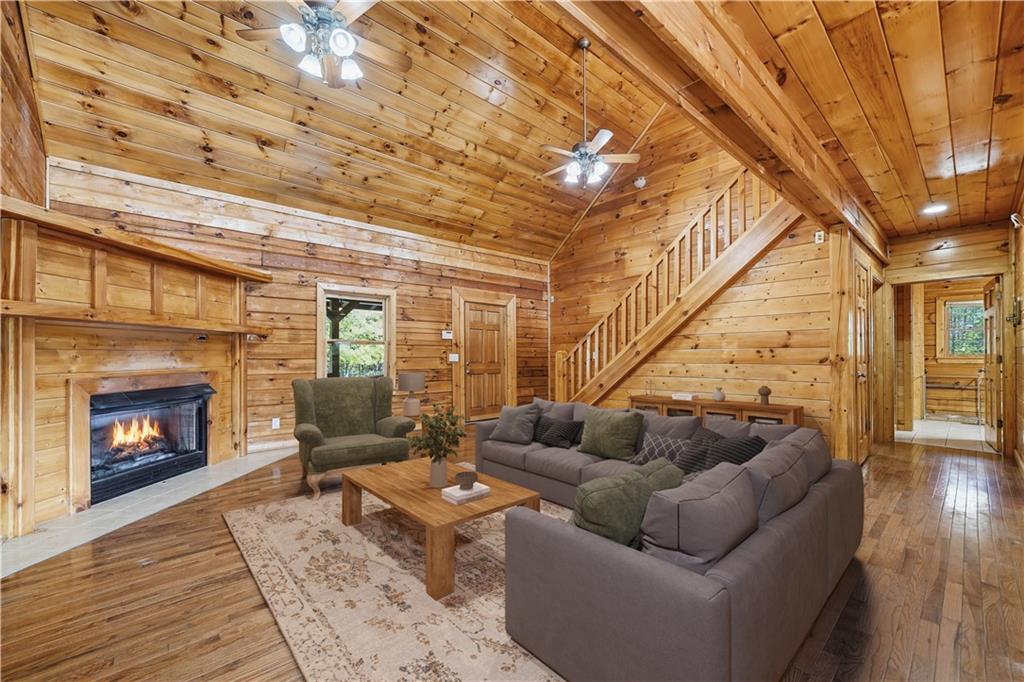 1384 Crystal Lane Northeast Ranger, GA 30734 - Photo 7 of 53 a living room with furniture a fireplace and wooden floor