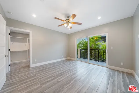 a view of a room with wooden floors and window