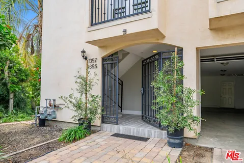 a view of a house with potted plants