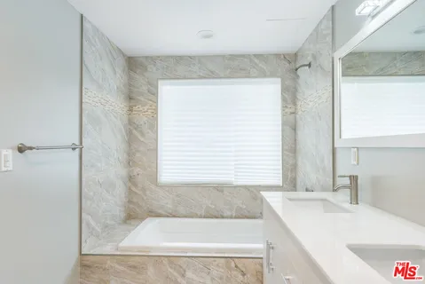 a bathroom with a sink toilet a mirror and shower