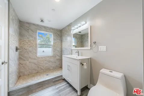 a bathroom with a sink a mirror and a shower