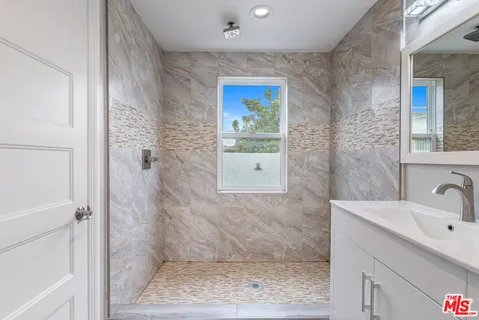 a view of a hallway with washer and dryer