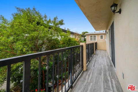 a view of a house with wooden deck