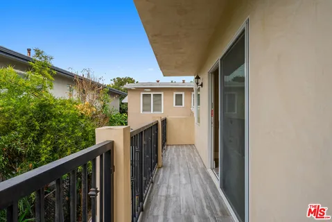 a view of a house with a small yard and a large window