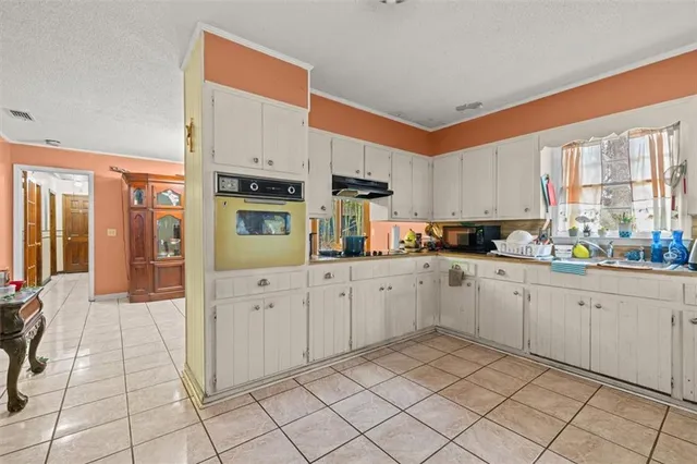 a kitchen with cabinets and window