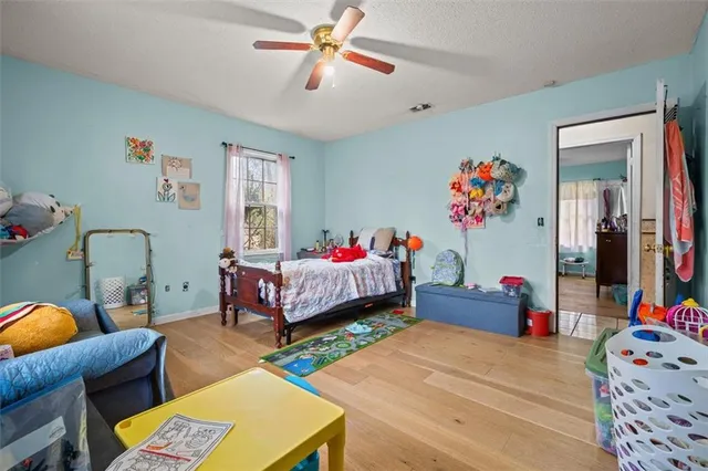 a bedroom with bed and a chandelier
