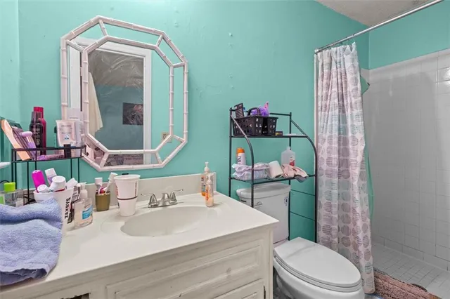 a bathroom with a sink toilet and mirror