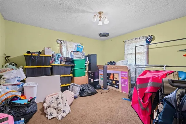 a bedroom with furniture and a chandelier