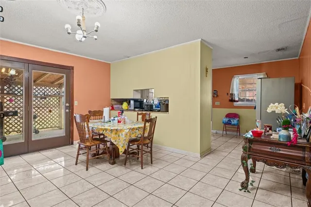 a view of a dining room with furniture and chandelier
