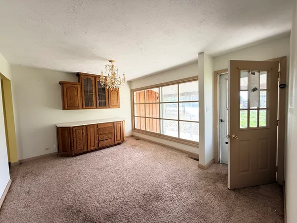 a large bedroom with a bed and a large window