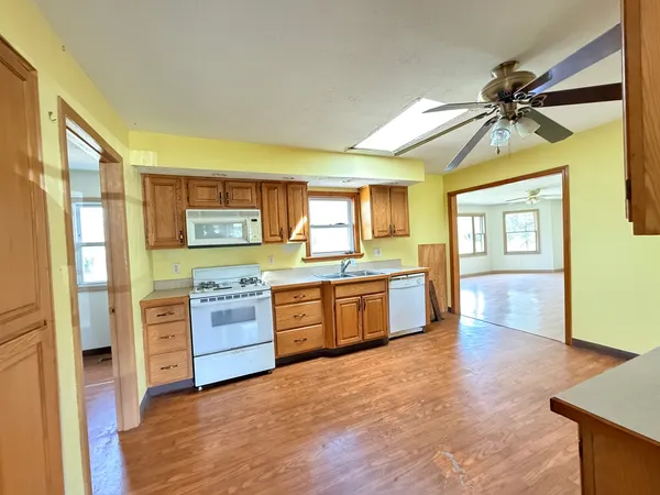 a kitchen with stainless steel appliances a stove cabinets and wooden floor
