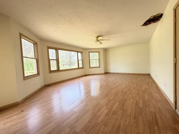 wooden floor in an empty room with a window