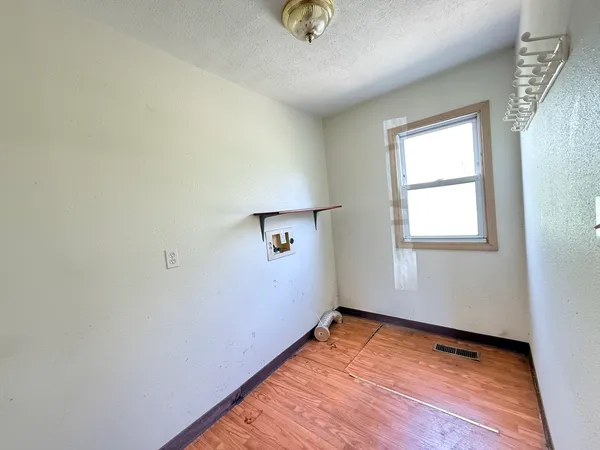 a view of a room with wooden floor and window