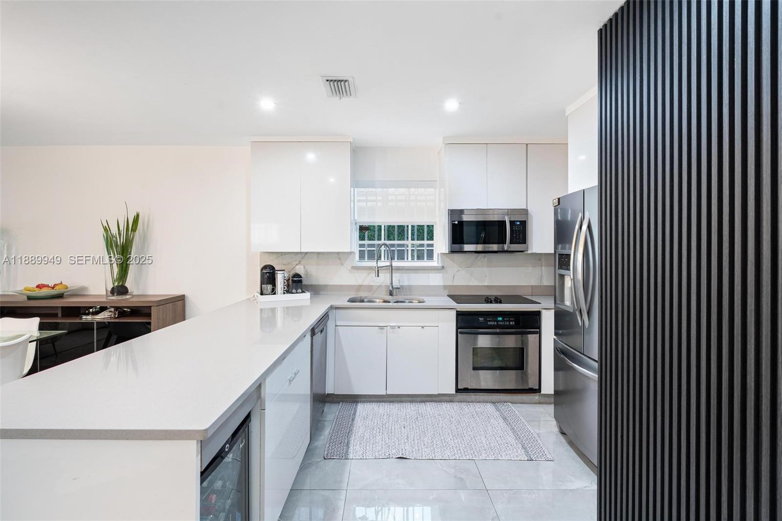2752 Southwest 11th Street Miami, FL 33135 - Photo 12 of 48 a kitchen with a sink a stove and oven