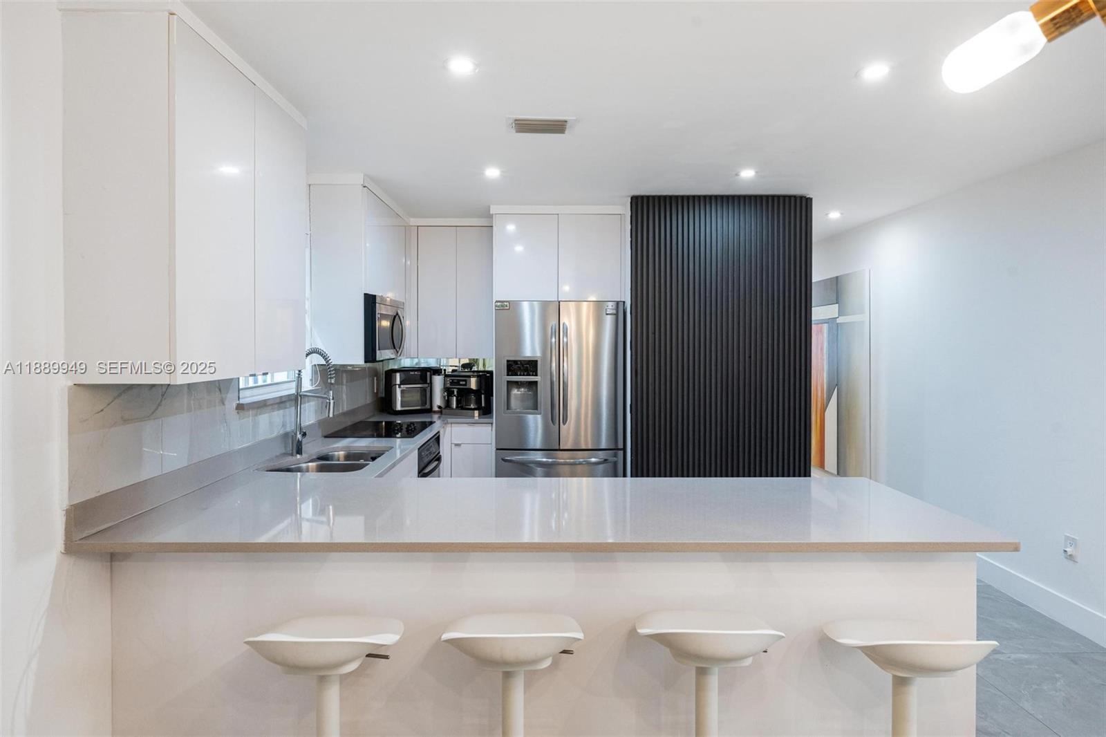 2752 Southwest 11th Street Miami, FL 33135 - Photo 15 of 48 a kitchen with a sink cabinets and refrigerator