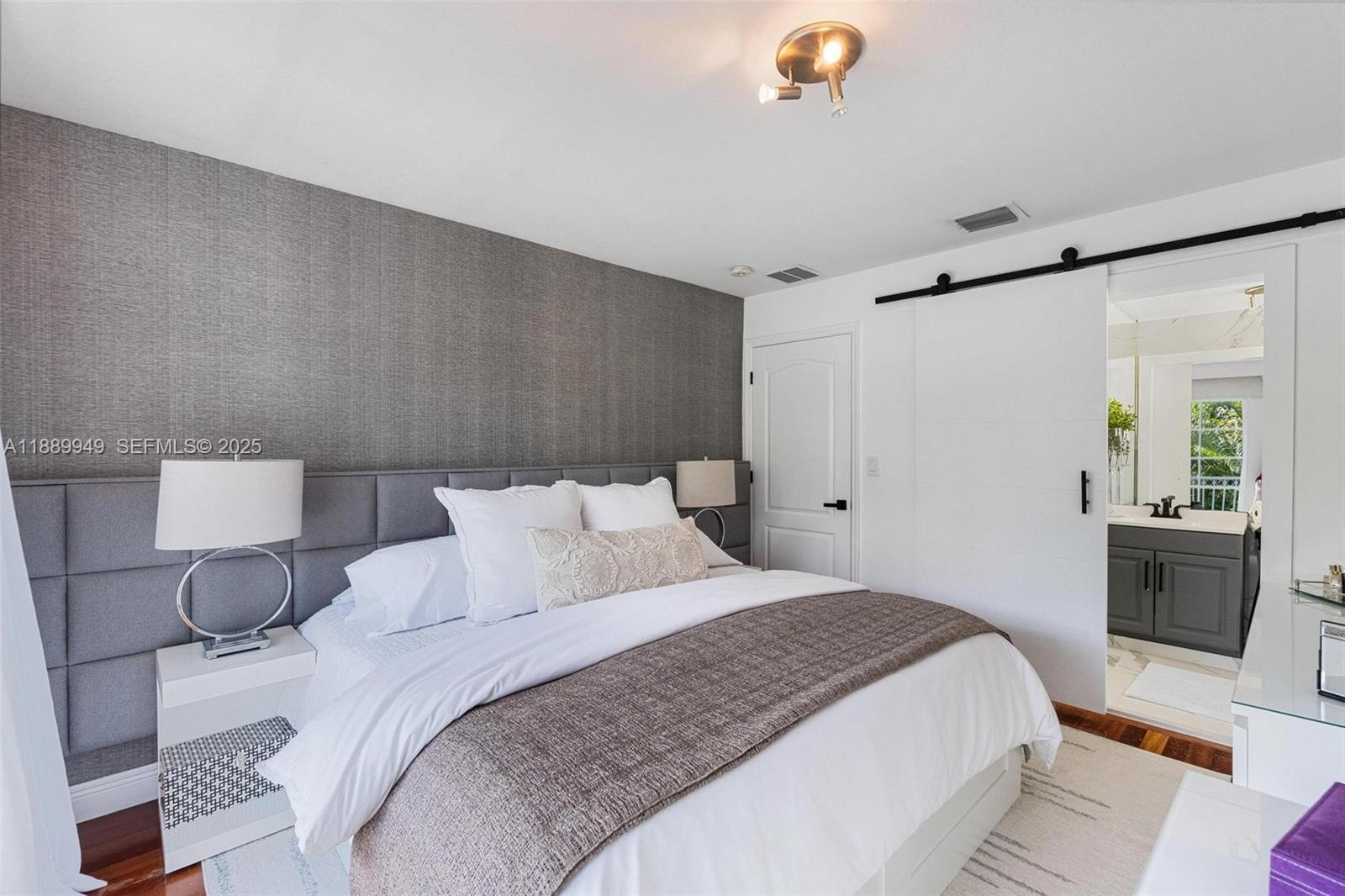 2752 Southwest 11th Street Miami, FL 33135 - Photo 19 of 48 a bedroom with a bed and a chandelier