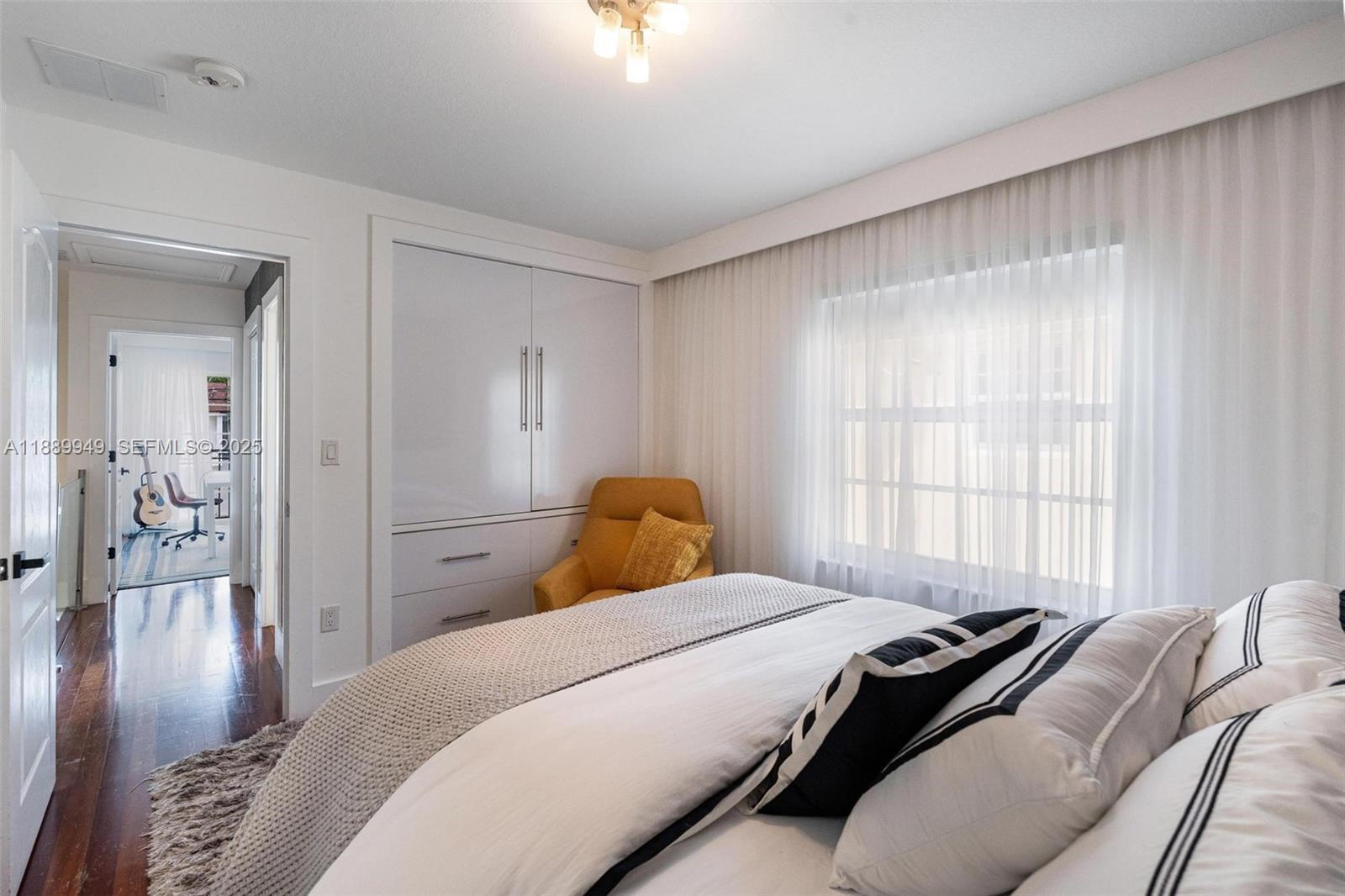 2752 Southwest 11th Street Miami, FL 33135 - Photo 27 of 48 a bedroom with a bed and wooden floor