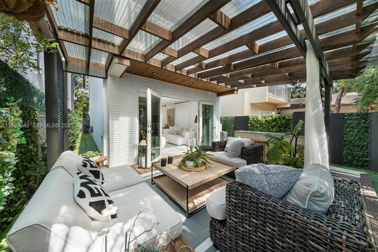 2752 Southwest 11th Street Miami, FL 33135 - Photo 31 of 48 a living room with patio furniture and a floor to ceiling window