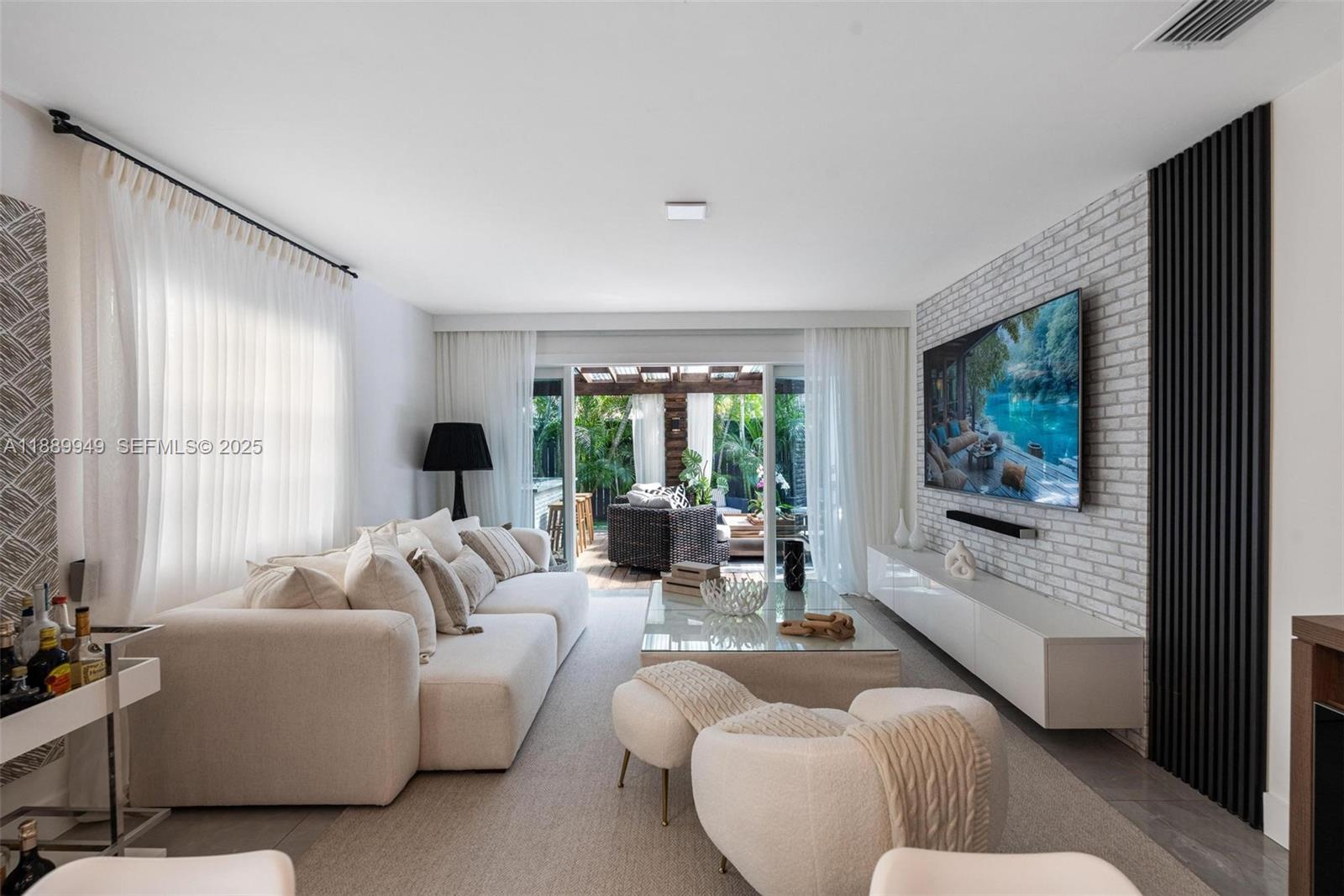 2752 Southwest 11th Street Miami, FL 33135 - Photo 8 of 48 a living room with furniture large windows and a flat screen tv