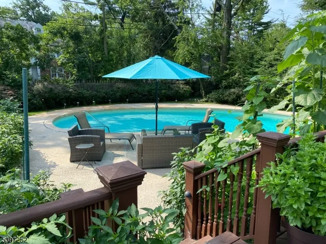 a view of table and chairs under an umbrella