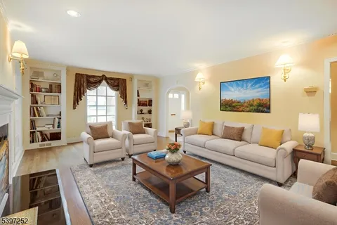 a living room with furniture a rug and a large window