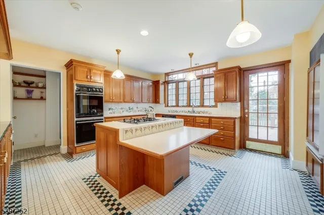 a large kitchen with stainless steel appliances granite countertop a stove and a refrigerator
