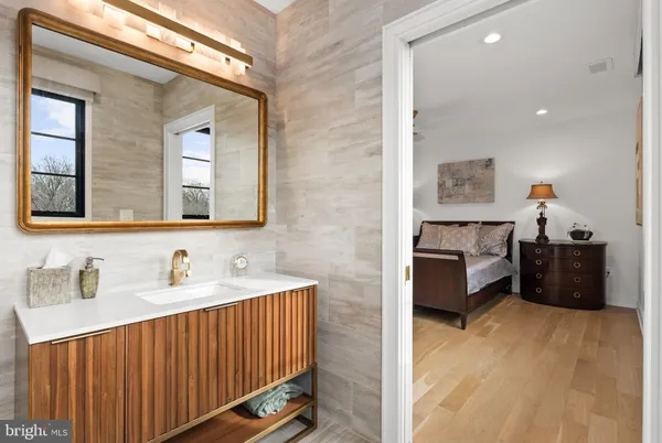 a kitchen with stainless steel appliances granite countertop a refrigerator sink and white cabinets