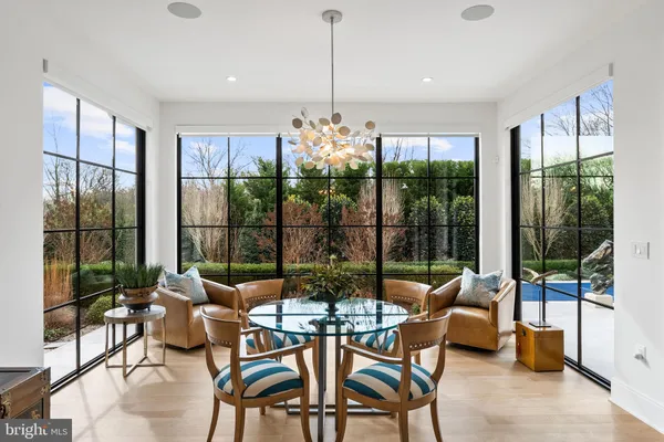 a living room with furniture large windows and a fireplace