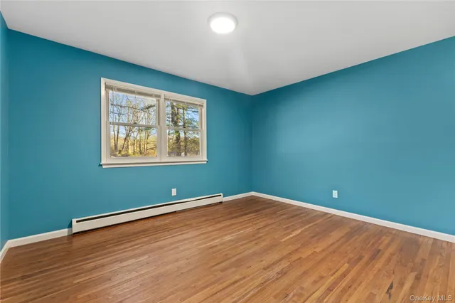 a view of a room with wooden floor and window