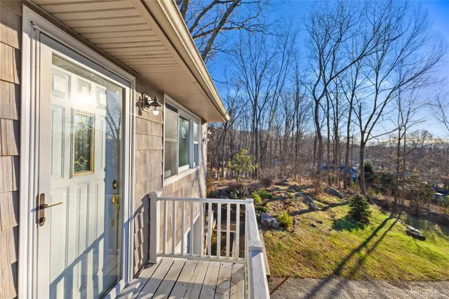 a view of balcony with wooden floor and outdoor seating