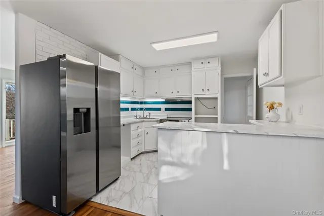 a kitchen with stainless steel appliances cabinets a refrigerator and a sink