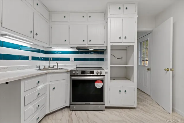 a kitchen with stainless steel appliances granite countertop a stove and a refrigerator