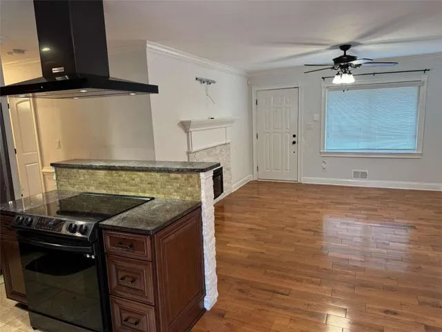 a kitchen with granite countertop a stove and a sink