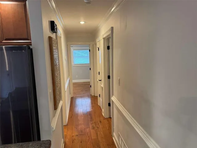 a view of hallway with wooden floor