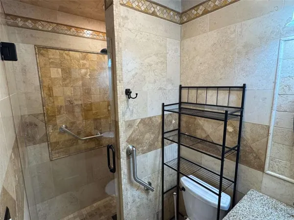 a bathroom with a toilet and a shower