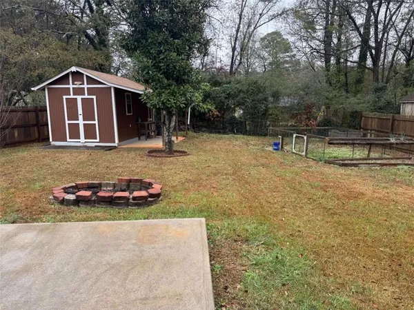 a open kitchen with refrigerator stove and wooden floor