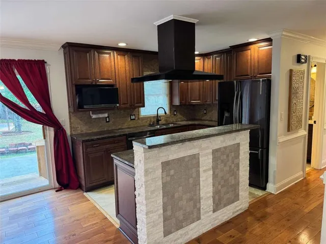 a kitchen with stainless steel appliances granite countertop a stove a refrigerator and a sink