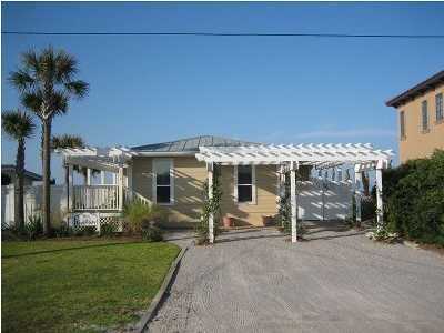 630 Blue Mountain Beach Road Santa Rosa Beach, FL 32459 - Photo 1 of 26 a front view of a house with garden
