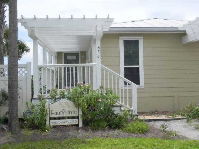630 Blue Mountain Beach Road Santa Rosa Beach, FL 32459 - Photo 2 of 26 a view of a house with brick walls and plants
