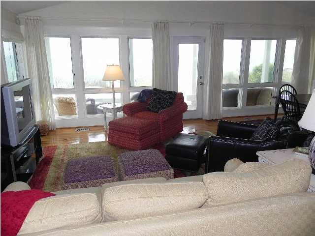 630 Blue Mountain Beach Road Santa Rosa Beach, FL 32459 - Photo 11 of 26 a living room with furniture a large window and flat screen tv