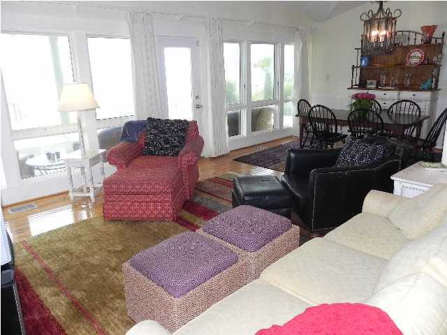 630 Blue Mountain Beach Road Santa Rosa Beach, FL 32459 - Photo 14 of 26 a living room with furniture and wooden floor