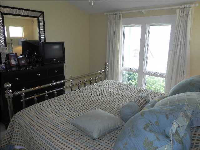 630 Blue Mountain Beach Road Santa Rosa Beach, FL 32459 - Photo 15 of 26 a bedroom with a bed and a mirror on dresser