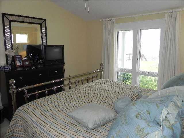 630 Blue Mountain Beach Road Santa Rosa Beach, FL 32459 - Photo 17 of 26 a bedroom with a bed and a large mirror